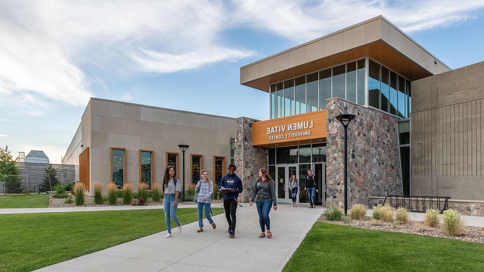 Diverse group of happy students leaving university center